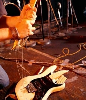 smashing guitar on stage